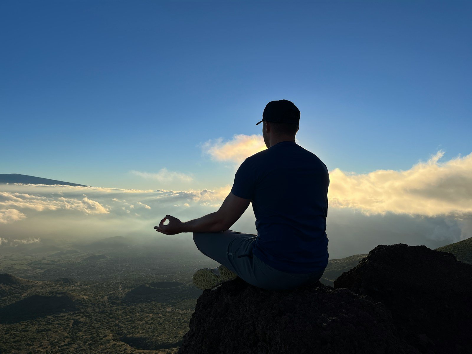 People meditating on a mountain in nature